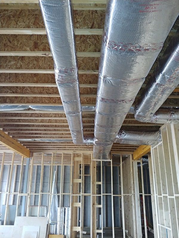 Insulated duct runs in a house under construction
