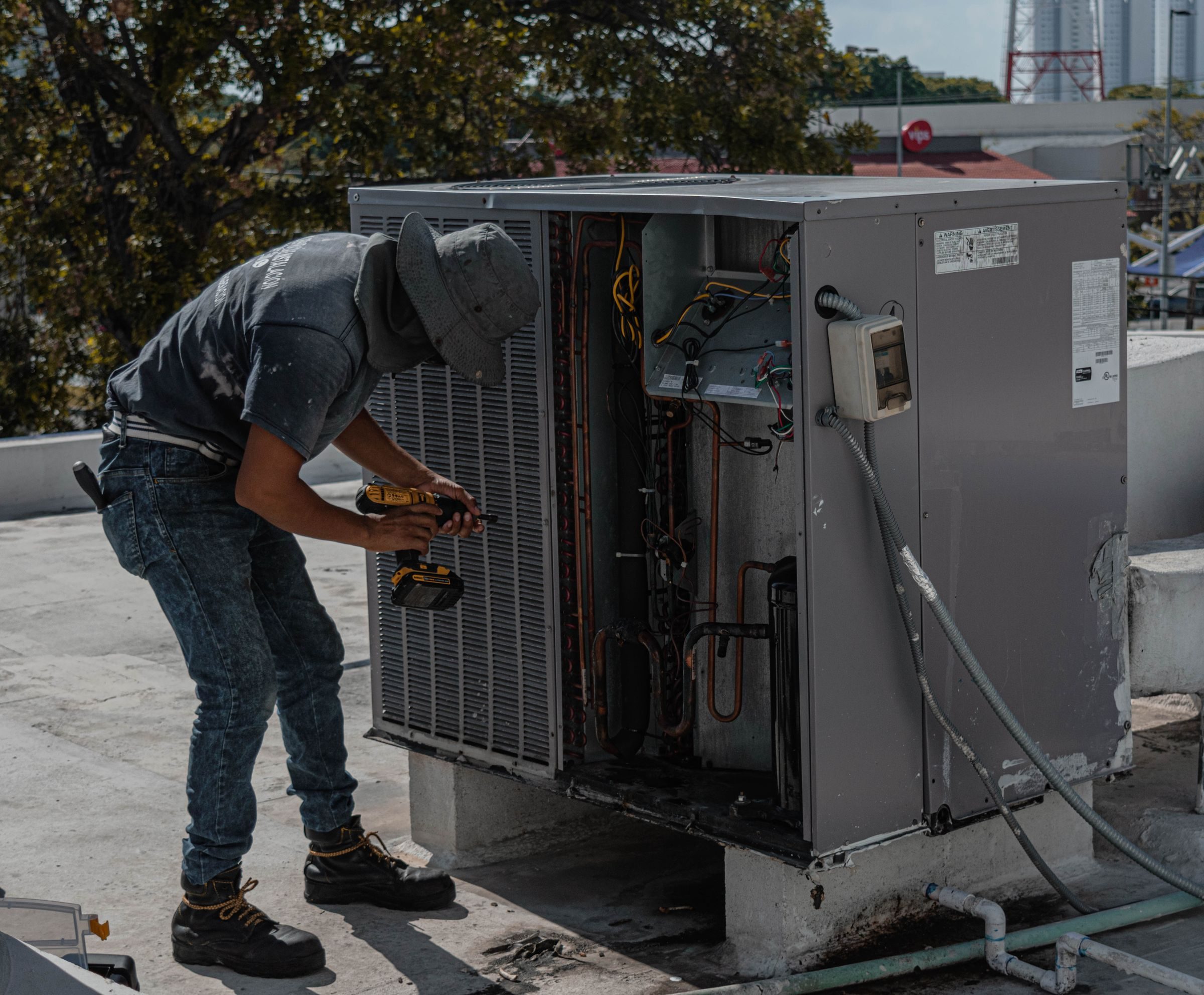 Technician repairing an air conditioning unit